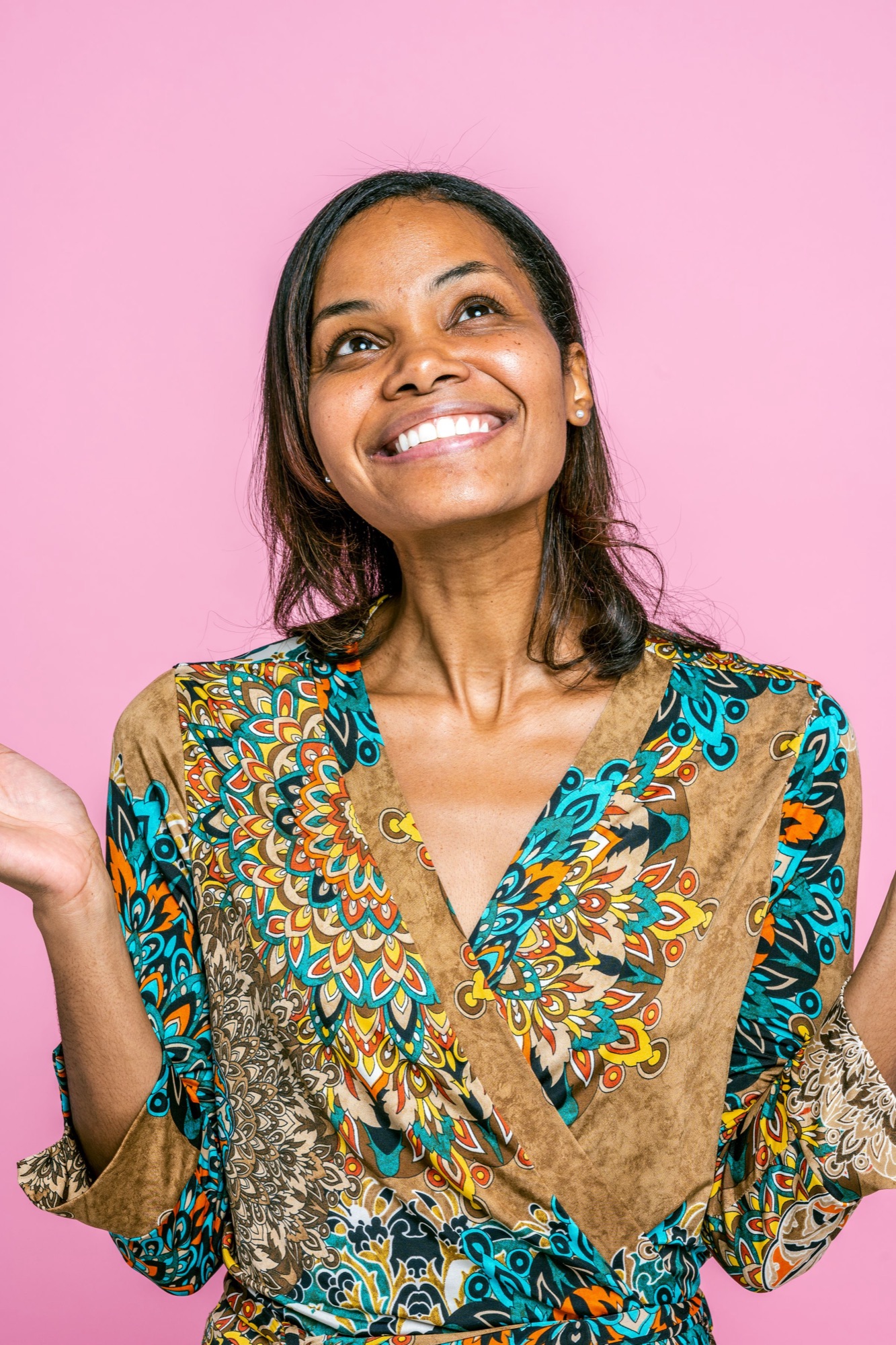A smiling woman looking up, relaxed and joyful